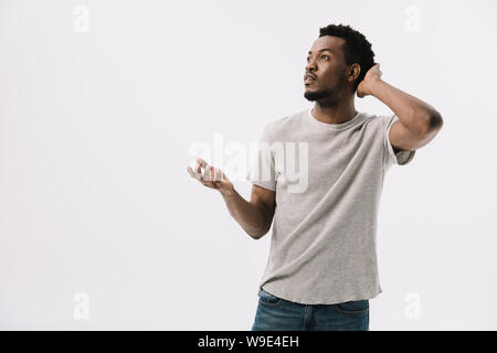 confused african american man gesturing and touching hair isolated on white Stock Photo