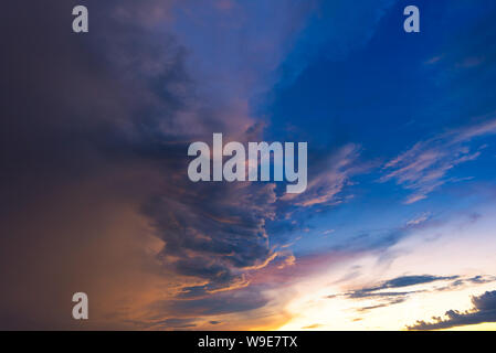 Dramatic sky with storm cloud before raining during sunset. Stock Photo