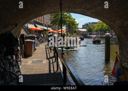 Leiden, Holland - July 05, 2019: Corridor, walking path under the bridge over the Nieuwe Rijn canal Stock Photo