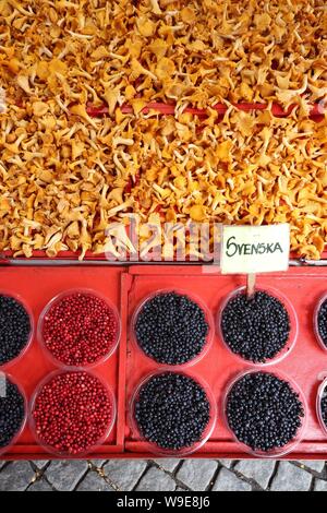 Food market of Hotorget in Stockholm, Sweden. Wild forest food: blueberries, lingonberries and chanterelle mushrooms. Stock Photo