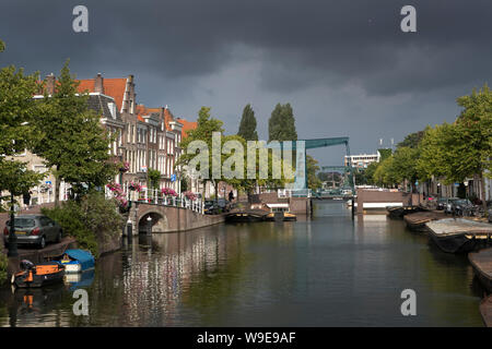 Leiden, Holland - August 2, 2019: Rijn bridge over the Nieuwe Rijn with dark cloudy sky in the center of Leiden Stock Photo