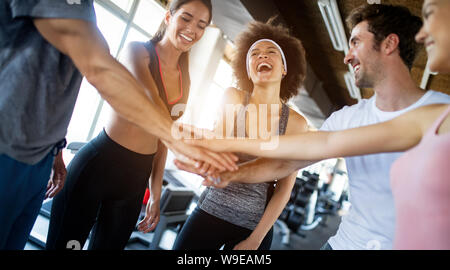 Happy gorup of healthy people training in gym Stock Photo