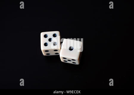 Two white dice on a black background. Stock Photo