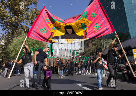 Shiites take to the streets during the holy month of Muharram to commemorate the death of the third Imam, Hussein, more than 1300 years ago in Karbala Stock Photo