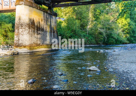 The Cedar River flows beneath a bridge in Maple Valley, Washington. Stock Photo