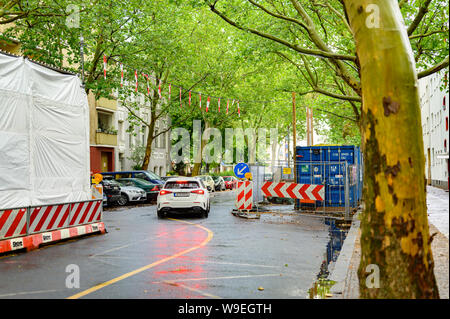 Berlin, Germany - July 13, 2019: Cityscape: A car is currently passing a construction site in downtown Berlin on a rainy day. Stock Photo
