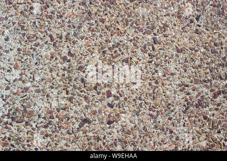Concrete surface with small pebbles. Small stone wall texture for background. Stock Photo