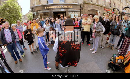 Edinburgh, Scotland, UK. 13th Aug, 2019. Edinburgh Fringe Festival was voted today as the number one attraction in the uk it saw performers enjoy the change in weather to take to the royal mile to promote their show and for street performers to entertain on their stage of the street. Credit: gerard ferry/Alamy Live News Stock Photo