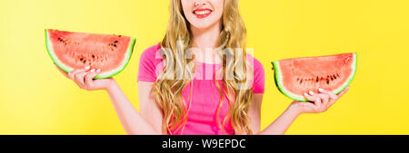 panoramic shot of smiling girl holding watermelon Isolated On yellow Stock Photo