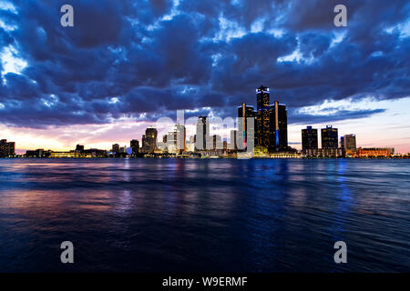 Skyline of Detroit Michigan USA seen from the city of Windsor Ontario Canada at sunset. Stock Photo