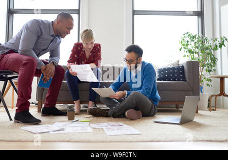 Multi-ethnic team of creative millenials collaborating on a brainstorm project Stock Photo