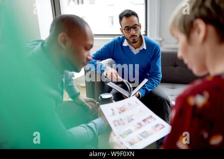 Multi-ethnic team of creative millenials collaborating on a brainstorm project Stock Photo