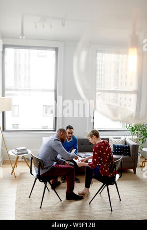 Multi-ethnic team of creative millenials collaborating on a brainstorm project Stock Photo