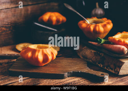 Preparing yellow pattypan squash for stuffing with minced meat Stock Photo