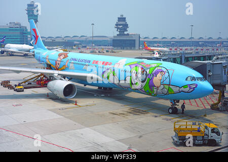 HONG KONG -18 JUL 2019- View of an Airbus A330 airplane from China Eastern Airlines (MU) painted in a Toy Story special livery at the busy Hong Kong I Stock Photo
