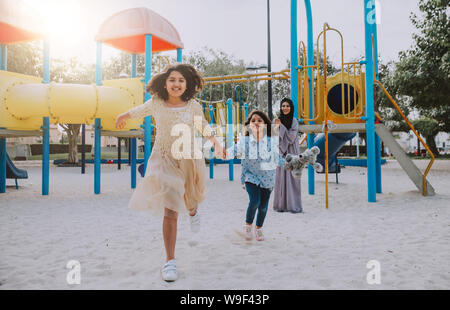 Mom and daughters spending time together at the park, in Dubai Stock Photo
