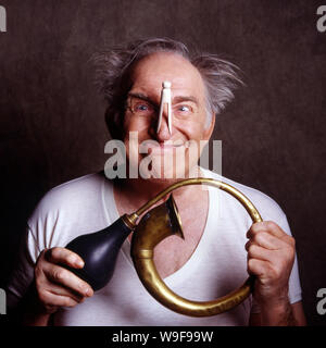 Crazy old man with clip on his nose Stock Photo