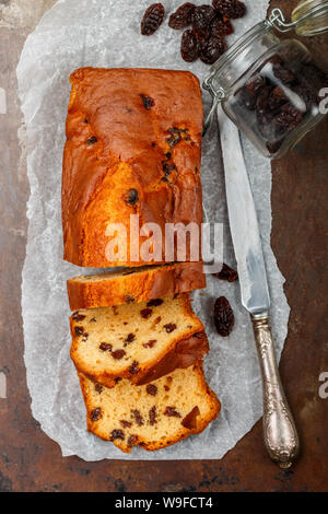 Homemade freshly baked cake loaf with raisins. Traditional treat for tea or coffee. Delicious breakfast. Pound cake. Selective focus, top view Stock Photo