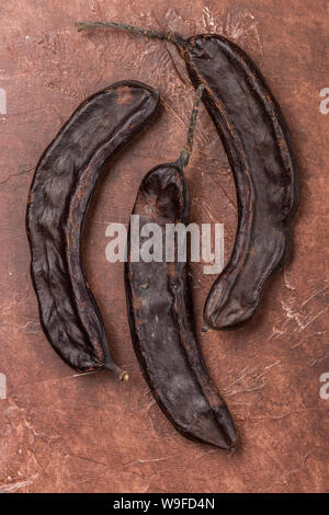 Carob. Healthy organic sweet pods with seeds. Healthy eating. Selective focus, top view Stock Photo