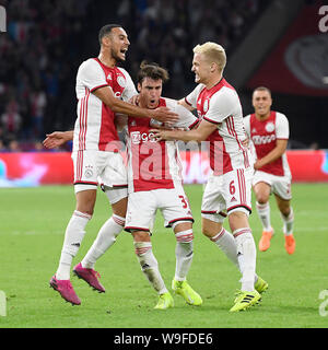 AMSTERDAM , 13-08-2019 , Johan Cruijff ArenA , Champions League third qualifying round season 2019-2020 , Ajax player Noussair Mazraoui , Ajax player Nico Tagliafico and Ajax player Donny van de Beek celebrating the 2-1 during the match Ajax - PAOK Stock Photo