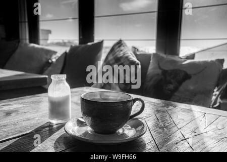 Steaming cup of coffee on wooden table Stock Photo