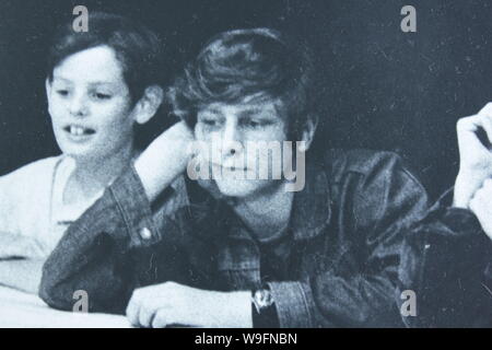 Fine black and white art photography from the 1970s of school boys hanging out in their classroom listening to a lecture Stock Photo