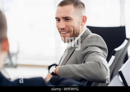 happy businessman discussing with colleague new business plan. Stock Photo