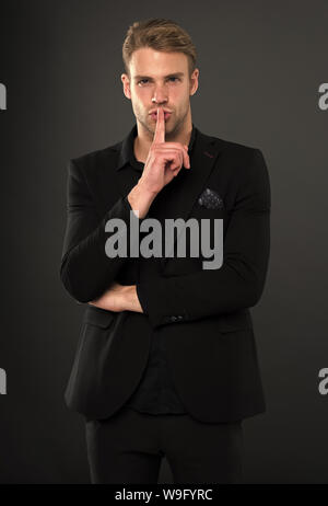 Man elegant manager wear black formal outfit on dark background. Reasons black is the only color worth wearing. Elegance in simplicity. Rules for wearing all black clothing. Black fashion trend. Stock Photo