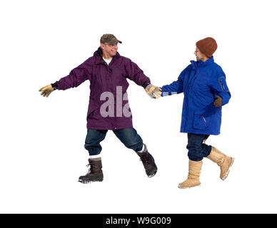 Senior couple holding hands and walking in winter clothes. Horizontal shot. Isolated on white. Stock Photo