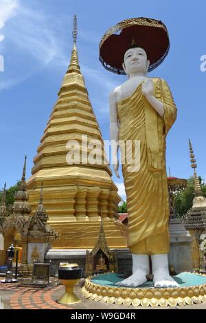 Buddha Statue and Chedi, Wat Phra That Chom Chaeng, Phrae Province, Thailand, Founding at the End of the 13th Century, Gilded Buddha Statue Stock Photo