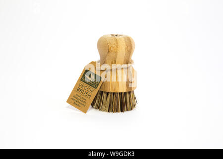 Go Bamboo branded veggie brush with bass fibres, twine tag. Biodegradable materials. Isolated on white background Sustainability concept. Low waste. Stock Photo