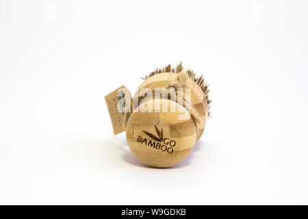 Go Bamboo branded veggie brush with bass fibres, twine tag. Biodegradable materials. Isolated on white background Sustainability concept. Low waste. Stock Photo