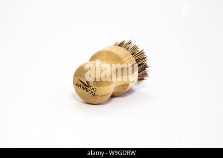 Go Bamboo branded veggie brush with bass fibres, twine tag. Biodegradable materials. Isolated on white background Sustainability concept. Low waste. Stock Photo