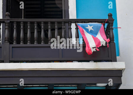 Puerto Rico protests - a tattered Puerto Rico flag flies in old San Juan Puerto Rico -  a torn Puerto Rican flag flaps in the breeze Stock Photo