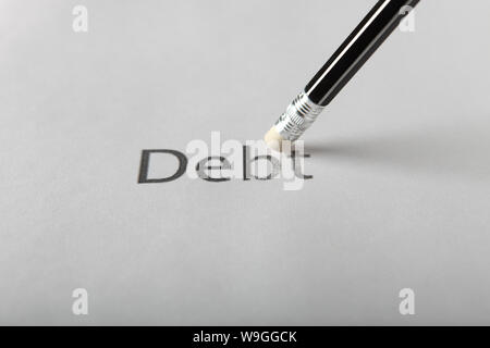 Studio shot of pencil erasing the word debt from piece of paper Stock Photo