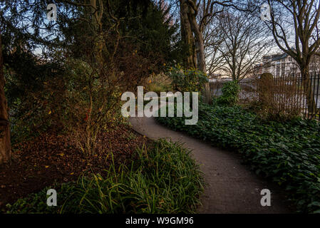 Pathways with green lawns, in the garden. Top view of curve walkway on beside a river Stock Photo