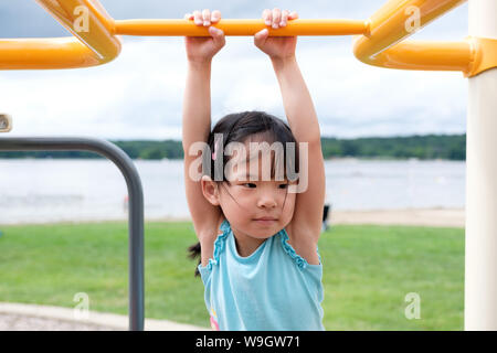 Active little toddler girl on the playground Stock Photo