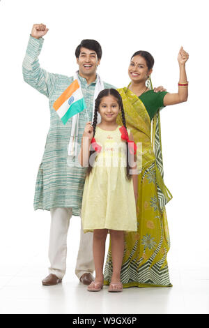 Rural family standing together and holding an Indian flag Stock Photo