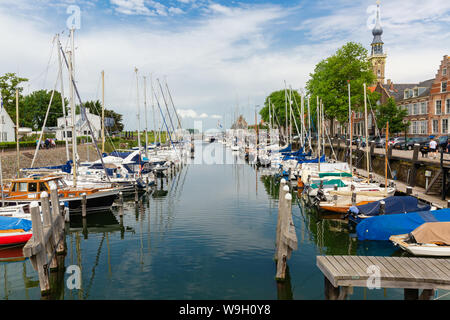 Veere, Netherlands - June 09, 2019: harbor with sailing boats in Veere, with unidentified people. Veere is famous for its picturesque old town and a p Stock Photo