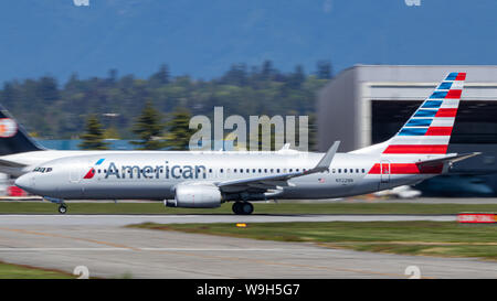 American Airlines Boeing 737-8 accelerating down the runway at Vancouver Intl. Airport. Stock Photo