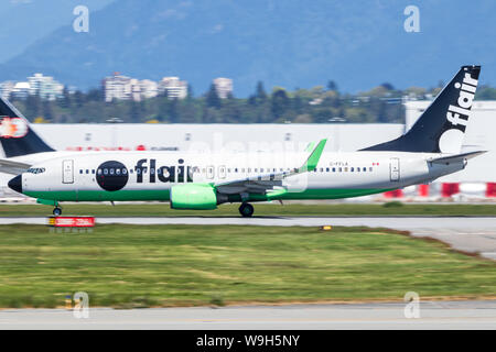Flair Airlines Boeing 737-8NG accelerating down the runway at Vancouver Intl. Airport. Stock Photo