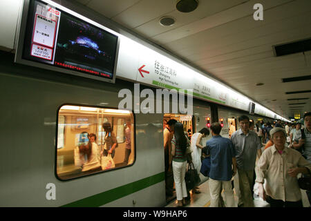 Passengers get on and off the subway train and the video and the subway train timetable are displayed on a PDP screen at the Peoples Square Subway Sta Stock Photo