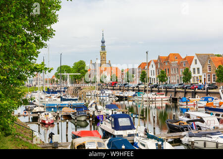 Veere, Netherlands - June 09, 2019: harbor with sailing boats in Veere, with unidentified people. Veere is famous for its picturesque old town and a p Stock Photo