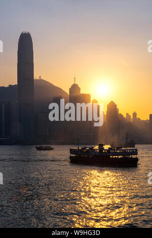 Hong kong traditional wooden chinese boat for tourist service in victoria harbor at sunset view from Kowloon side at Hong Kong Stock Photo