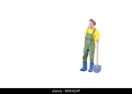 Close up of Miniature farmer people isolated with clipping path on white background Stock Photo