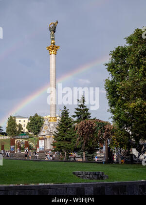 KIEV, UKRAINE-JULY 23, 2019: Independence Monument on Independence Square on the real rainbow background Stock Photo