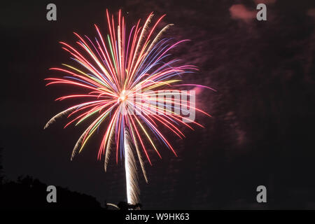 Beautiful fireworks display in the air with smokes. Summer time in Japan. This festival is called hanabi taikai of fireworks festival. Stock Photo