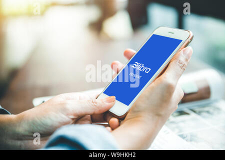 Facebook Libra coin logo icon on  smartphone screen, new internet currency using blockchain for modern world payment and bacnking. 26 July 2019,Bangko Stock Photo