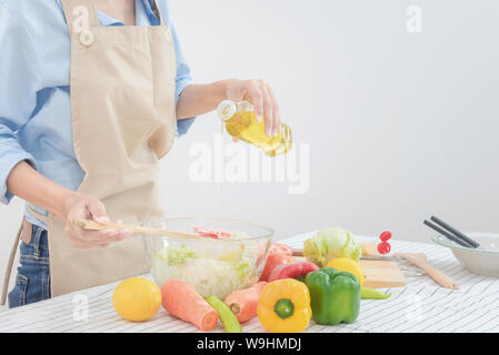 Young asian woman prepare healthy food salad at home for Healthy and dieting. Stock Photo