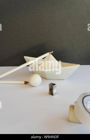 Desk of white pencil on a toy ship, Concept of creative work space and back to school Stock Photo